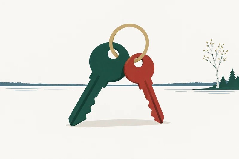 Two keys, one green and one red, joined on a single gold ring beside a calm lake.